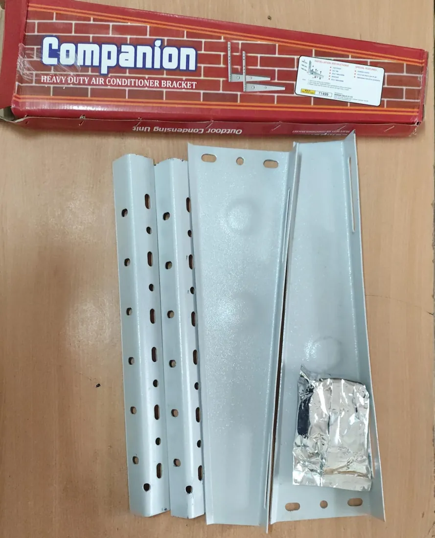 Companion heavy-duty AC outdoor unit bracket, parts laid out below its box, at Shree Suswani Refrigeration, Secunderabad